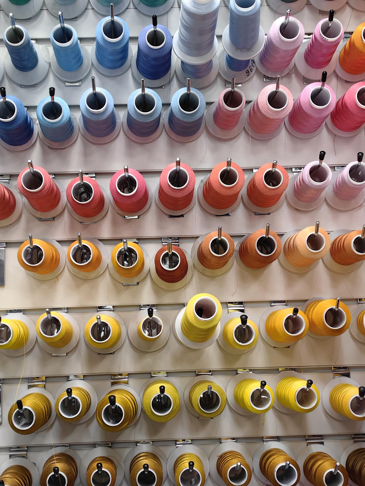workshop interior with embroidery machines and samples on walls