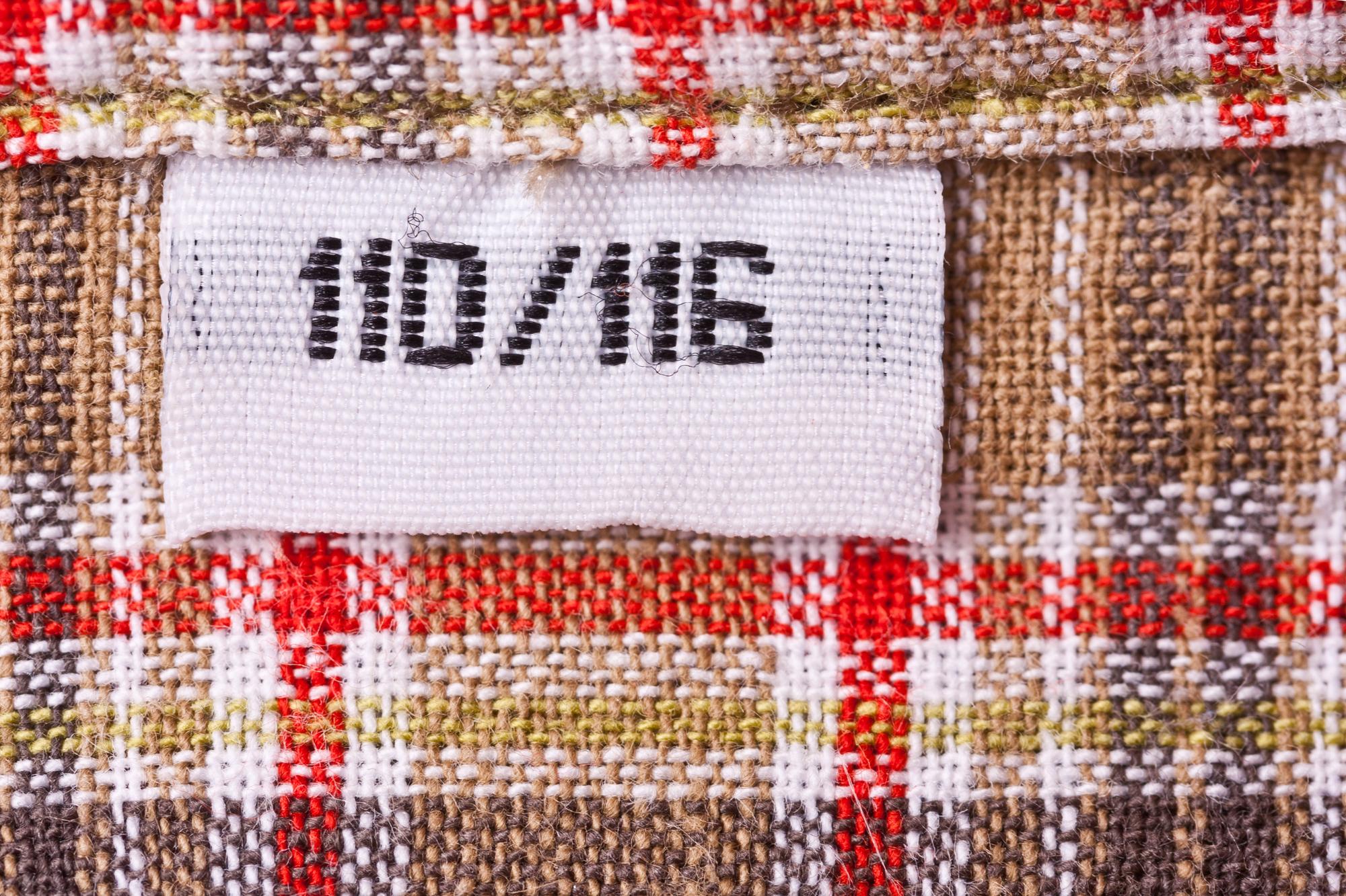 small series of embroidered labels arranged on table